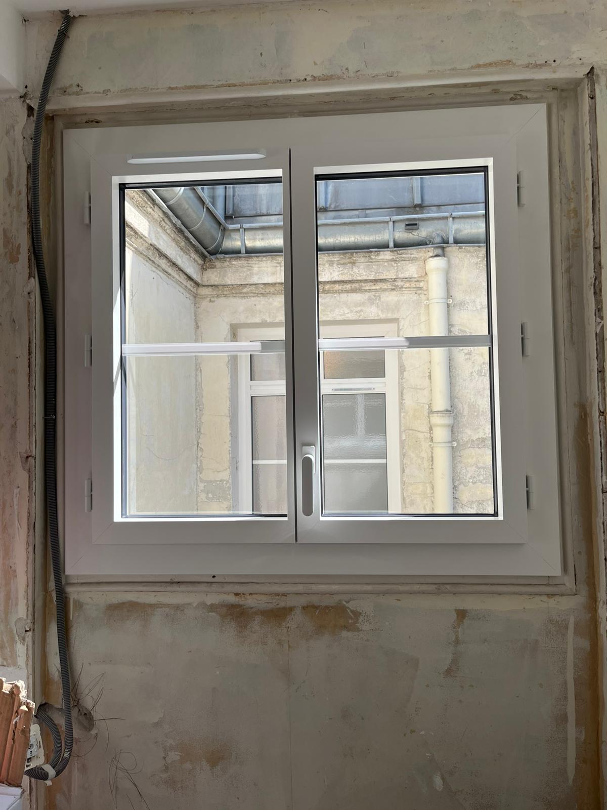 Fenêtre coulissante en aluminium noir avec grande baie vitrée offrant une vue panoramique